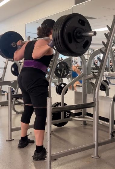 Sam squatting in a squat rack
